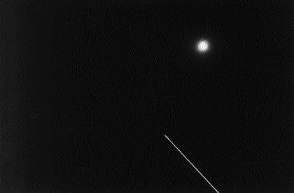 Photo of Discovery passing the moon (9,752 bytes)